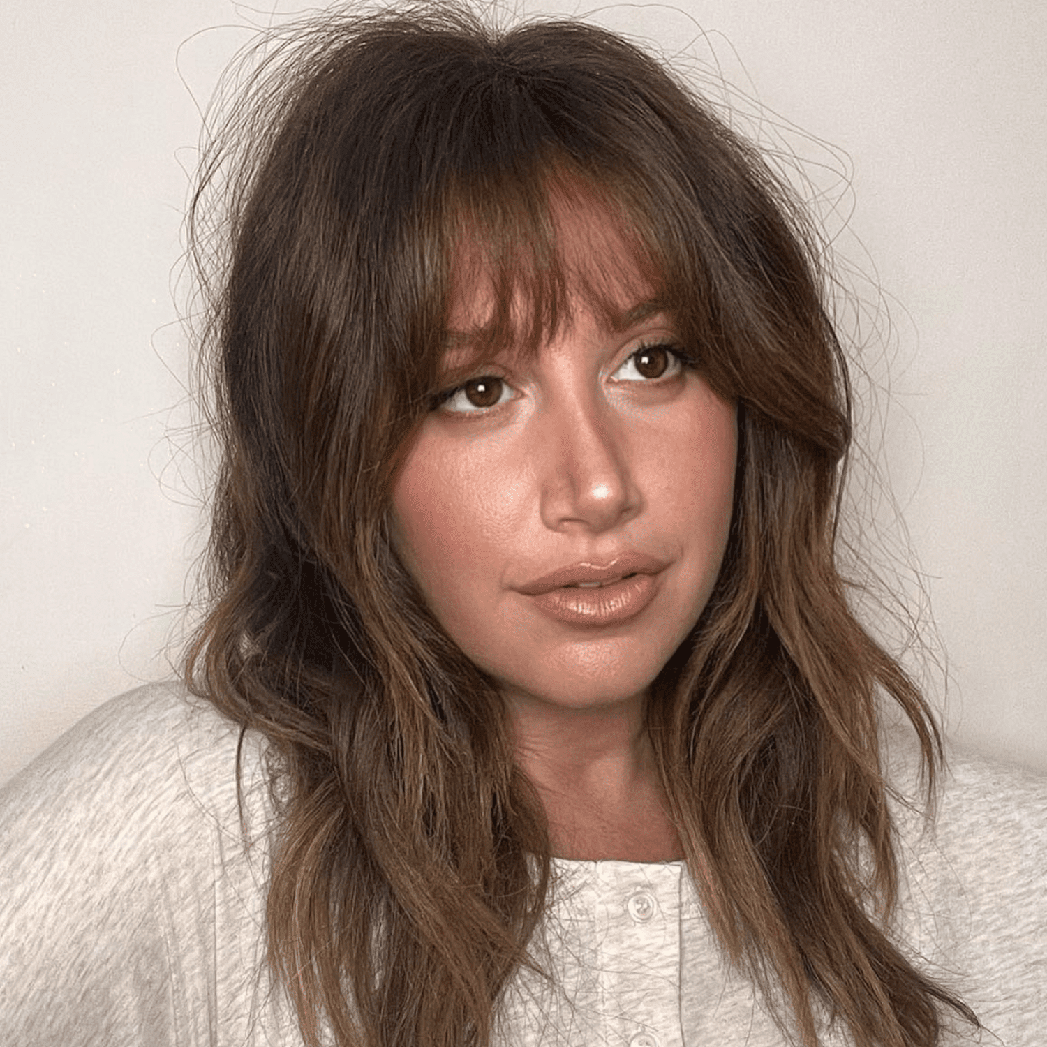 Ashley Tisdale debuts her french bangs on instagram with tousled wavy hair