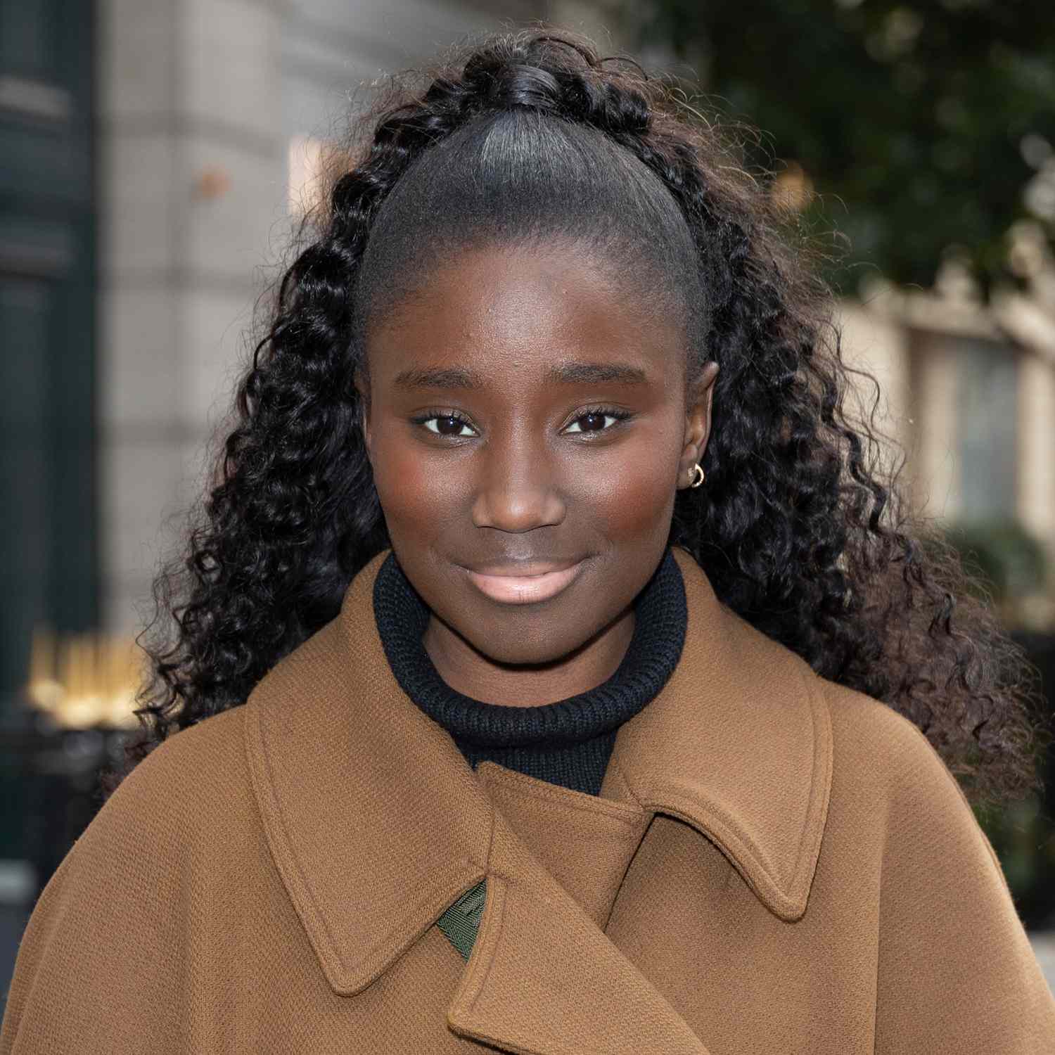 Actress Karidja Toure wears a classic high ponytail with sleek roots and wavy, natural texture in the back