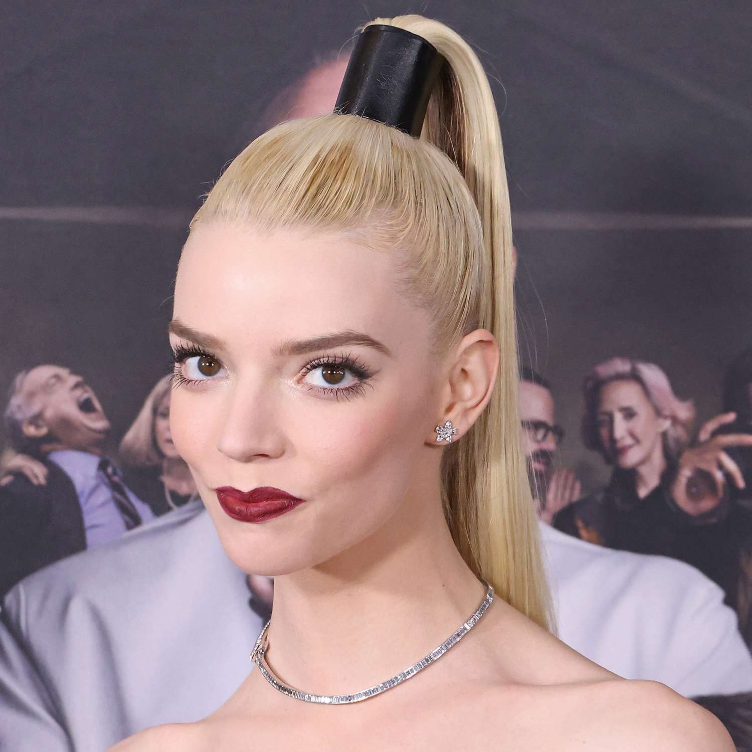 Anya Taylor-Joy attends a film premiere wearing a ponytail cuff holder for extra lift