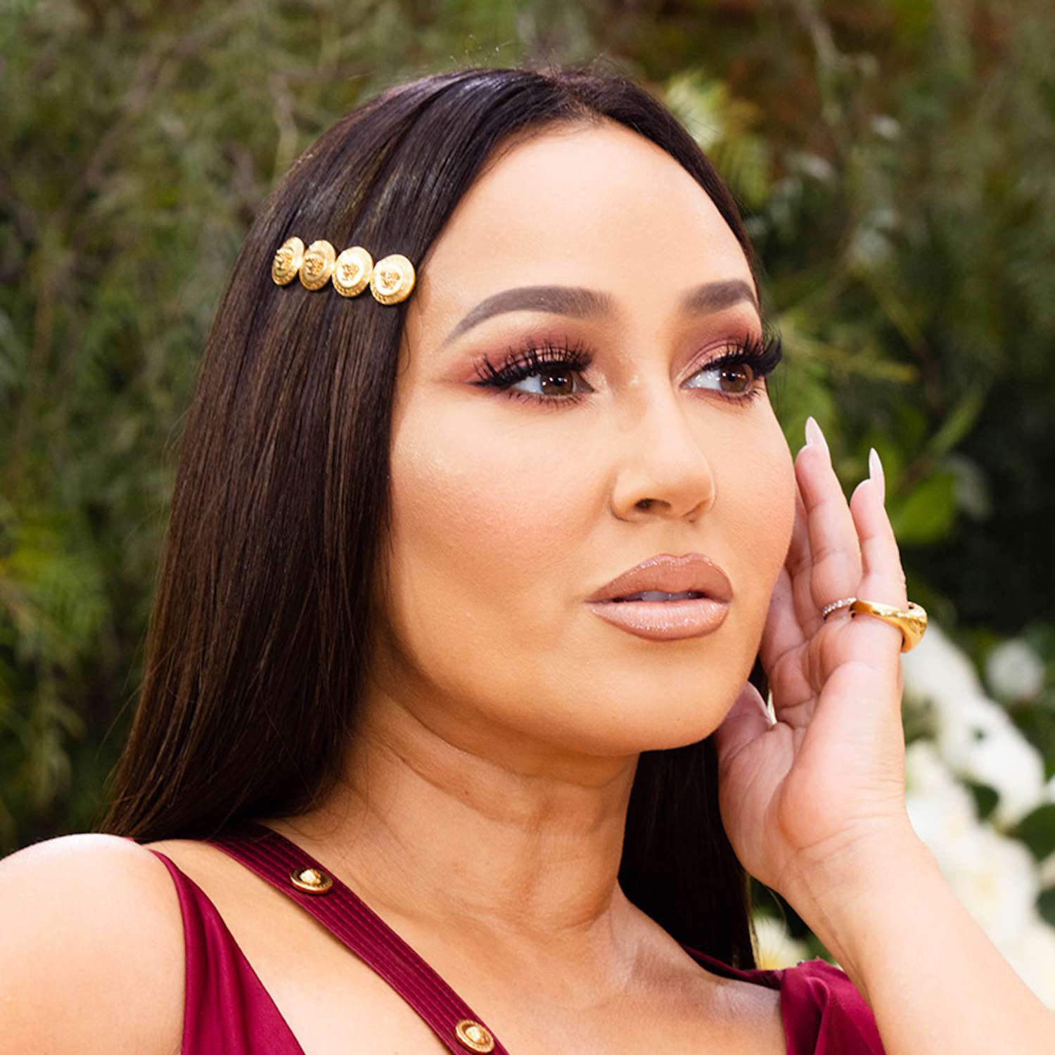 Adrienne Bailon Houghton in a gold barrette on straight smooth hair at the Academy Awards